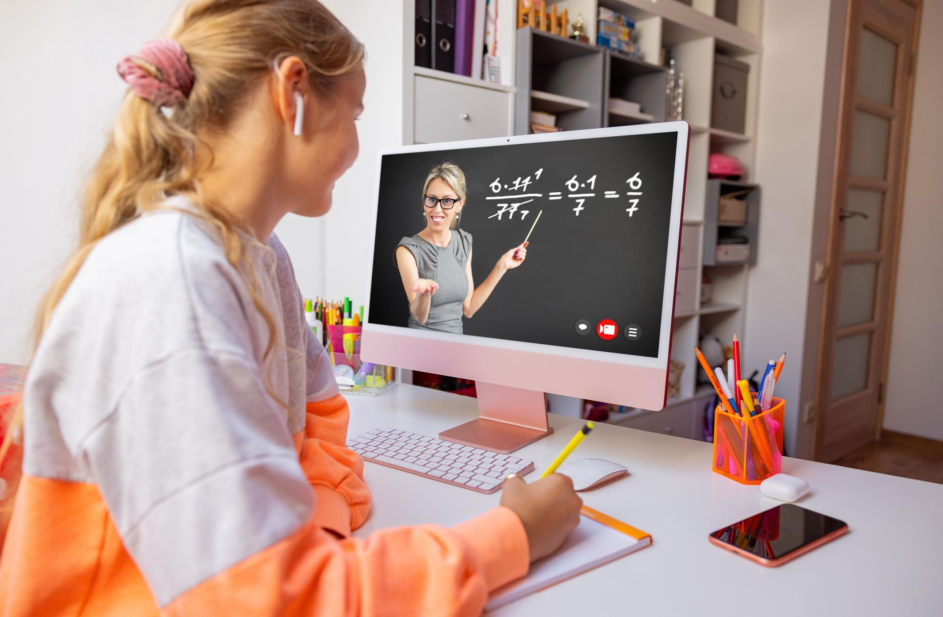 Girl studying at home and watching online class