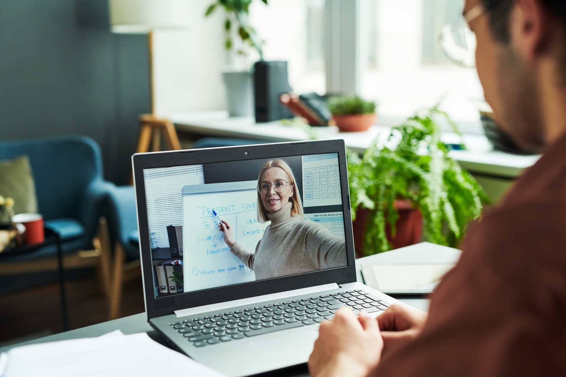 Laptop screen with mature blond confident teacher